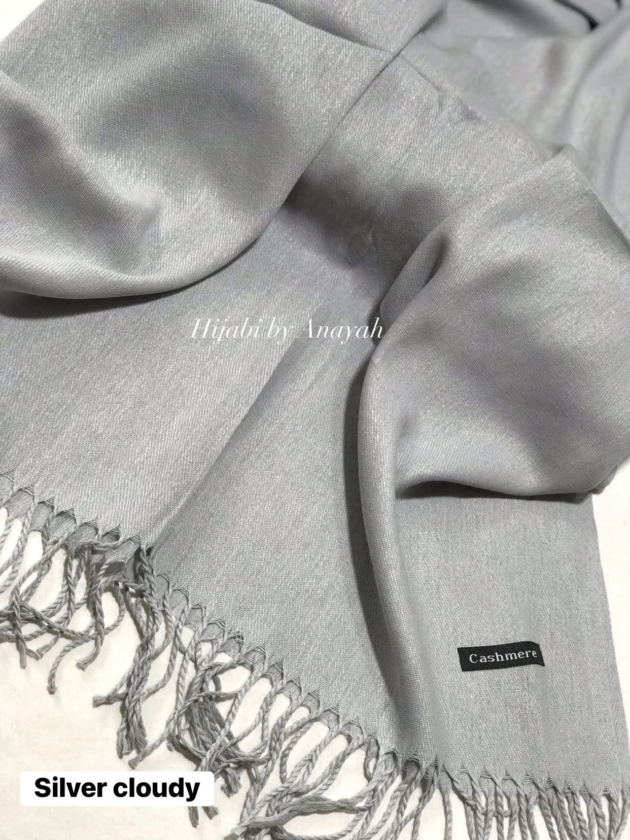 Gray hijab with fringes and 'Hijabi by Amayah' branding, displayed on a white background.