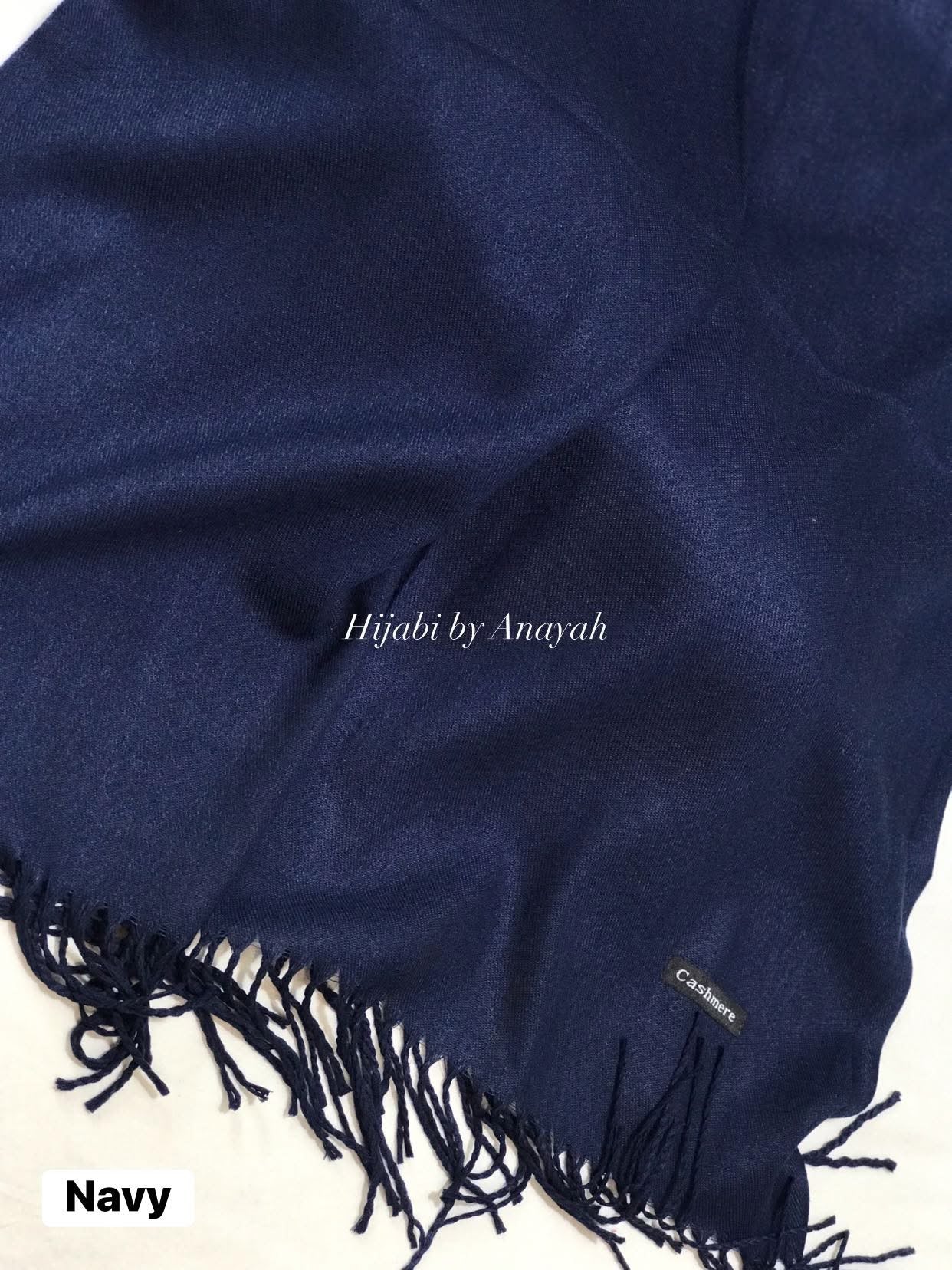 Navy blue hijab with tassels on a white background, branded 'Hijabi by Anayah'.