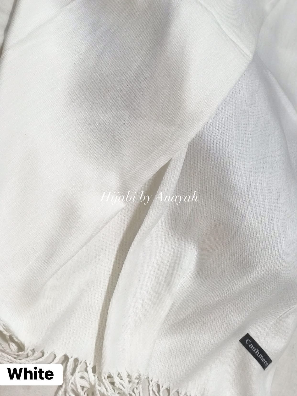 Close-up of white fabric with 'Himbi by Anayah' branding.